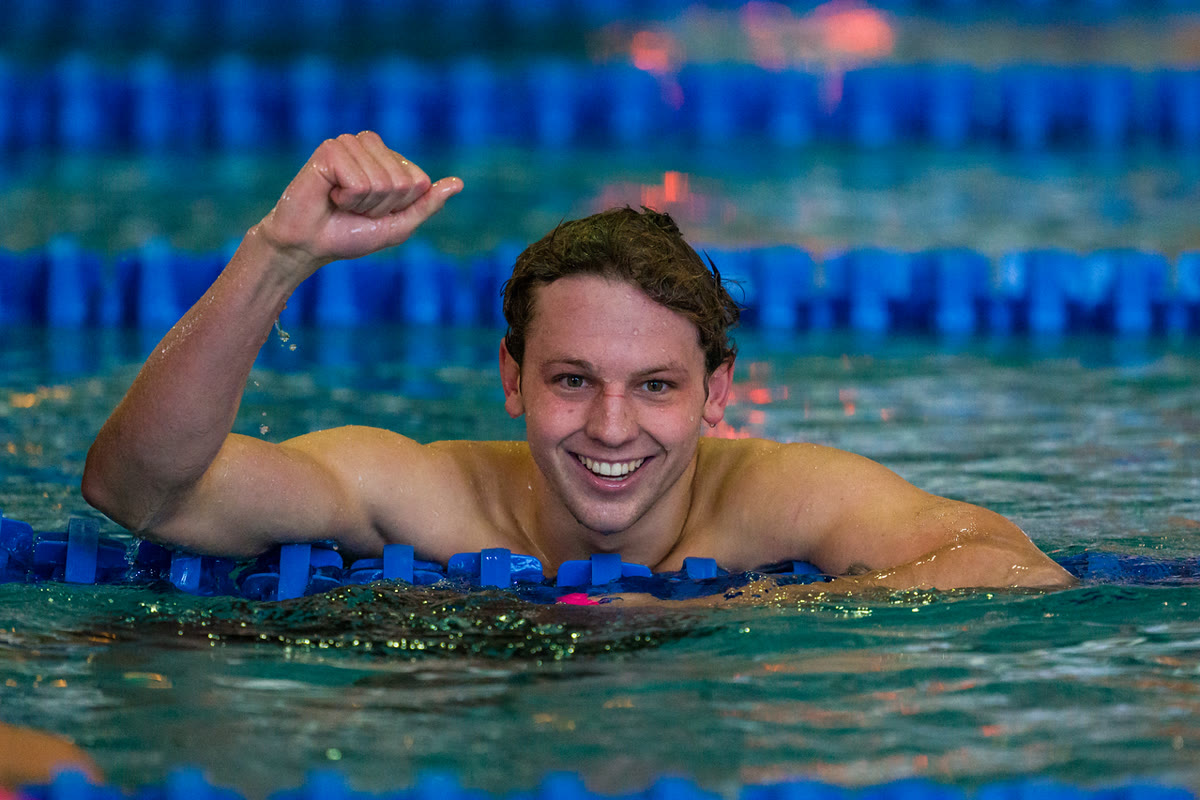 Nils Bognar celebrating in the pool after a race